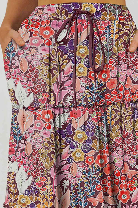 Close-up view of a floral maxi skirt with tiered layers and frill trim, highlighting the flowy design.