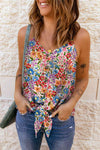 A floral-patterned V-neck cami top with a tie hem, styled with denim shorts, perfect for casual summer looks.