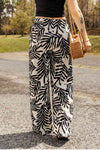 Back view of printed drawstring pants highlighting the loose, comfortable fit.