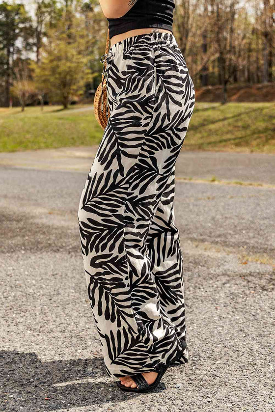 Side view showing the relaxed fit and drawstring waist of the printed pants.