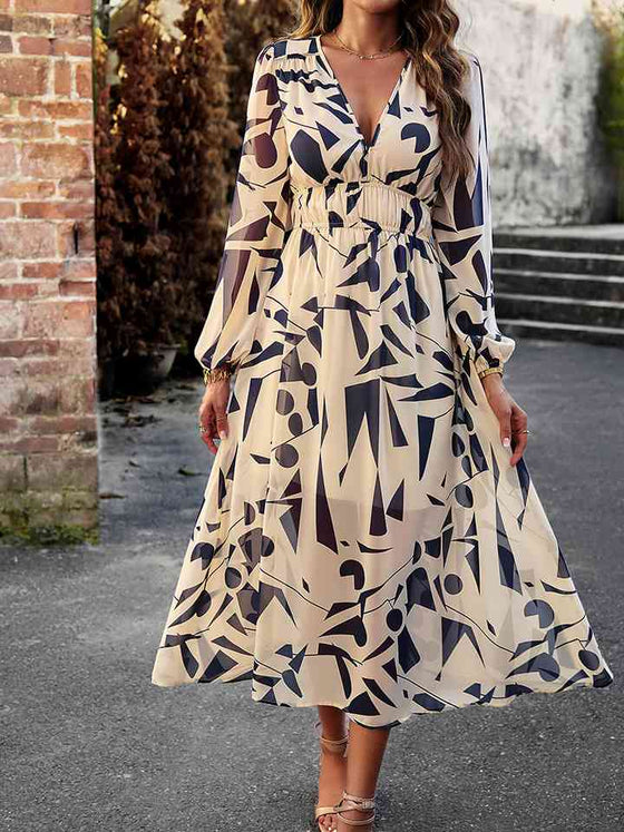 Front details of the Printed V-Neck Long Sleeve Midi Dress, featuring ruched waist and neckline design.